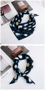 Close-up of leopard print triangle scarf tied in a knot showing blue and beige patterns