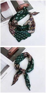 Close-up of geometric pattern silk scarf showing luxury texture and stitching detail