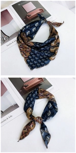 Detailed view of leopard and geometric print silk scarf with satin finish and navy accents