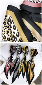Close-up of leopard and stripe print neck scarf showing premium silk texture and vibrant colors