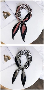 Detail of leopard print silk scarves with chic patchwork design and smooth satin texture