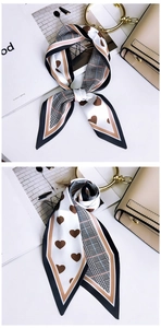Close-up of heart print satin skinny scarf with contrast border and pointed ends