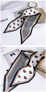 Detail of double-sided silk scarf with heart patterns and checkered design for bags