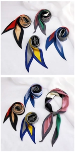 Detail of multi-color geometric silk scarf with striped patterns and smooth texture