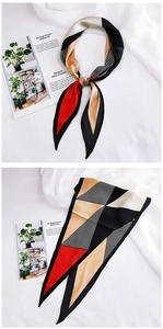 Macro detail of geometric patchwork silk scarf with red, beige, and black pattern stripes