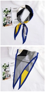 Detailed view of long geometric silk scarf showing blue and yellow color block patterns