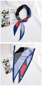 Detail of color-block geometric silk scarf with red, blue and striped patterns
