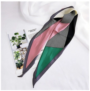 Detail of color-block geometric silk scarf used as a headband or neck scarf