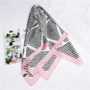 Detail of pink and black geometric silk square scarf with pattern and label texture