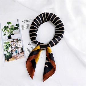 Detail of silk-satin scarf featuring diagonal stripes and geometric color-blocking