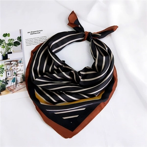 Close-up of silk striped square scarf with orange borders and elegant knot detail