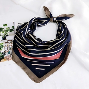 Navy blue striped square silk scarf with coral pink block accent for professional styling