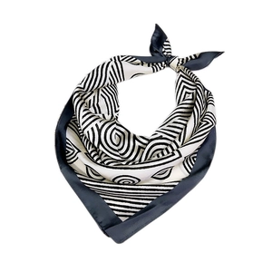 Silk-like square scarf with black and white geometric lines and concentric circle patterns