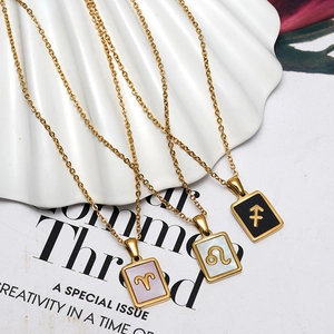 Detailed close-up of 18K gold zodiac necklaces with mother of pearl rectangular pendants