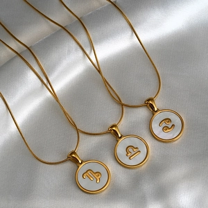 Three 18K gold-plated stainless steel zodiac necklaces with white shell inlay pendants