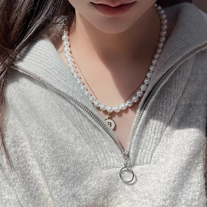 Layered necklace with shell pendant and 18K gold-plated stainless steel letter B charm