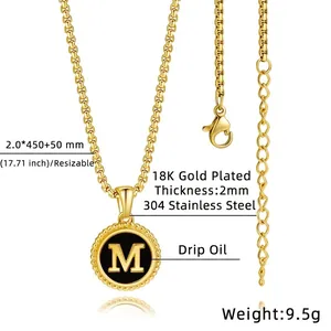 Macro shot of 18K gold plated stainless steel letter M pendant with black enamel finish