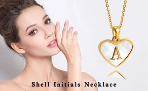 Detail of a heart-shaped shell necklace with a gold letter A pendant for women