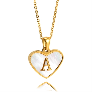 Golden heart necklace with white pearl shell and capital letter A pendant on white background