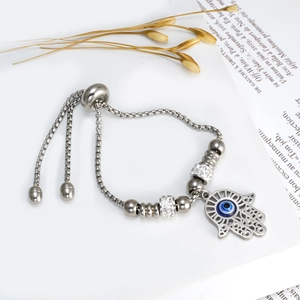 Detail of Hamsa Hand and Evil Eye charm on adjustable box chain stainless steel bracelet