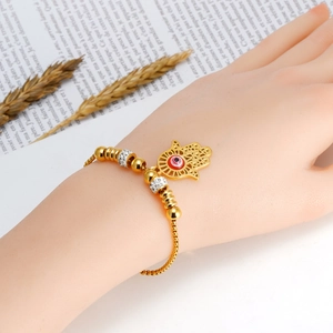 18K gold plated Hamsa hand bracelet with red evil eye charm on stainless steel chain