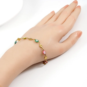 Detail of 18K gold-plated evil eye bracelet with colorful enamel beads and hollow hearts