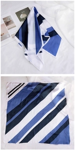 Détails d'un foulard carré en soie avec motifs géométriques à rayures bleues et noires