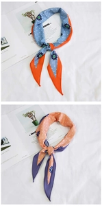 Detail of silk-like neckerchief with floral daisy prints and classic white polka dots