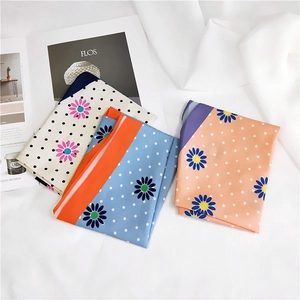 Polka dot sunflower silk scarves in white, light blue and orange on fashion magazine
