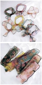 Detail of floral organza scarves showing light texture and colorful vintage patterns