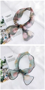 Detail of floral chiffon scarves with translucent texture tied in elegant bows