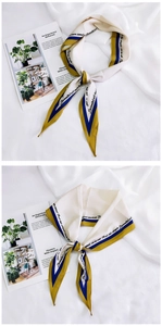 Macro detail of silk-feel scarf with French text print and blue-yellow border design
