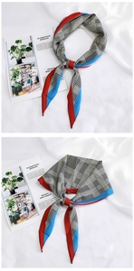 Detail of a chic houndstooth silk scarf with red and blue borders on a white magazine