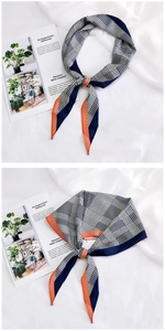 Detail of checkered patchwork silk twilly scarf styled on a minimalist magazine