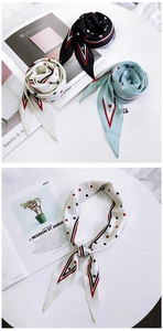 Close-up of silk-feel scarves with polka dot patterns and stylish striped borders