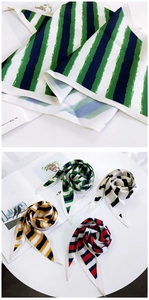Macro detail of multicolored striped silk scarves in green, blue, yellow, and red hues