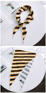 Detail of elegant striped twilly scarf showing colorful silk-like fabric and knotted bow style