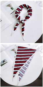 Detail of red, white and blue striped narrow silk scarf with paint brush texture effect