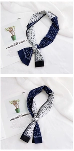Macro-opname van de marineblauw en wit geometrisch zijden twilly sjaaltje voor dames
