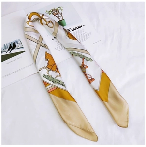 Detailed view of square silk scarf with golden equestrian horse and belt print pattern