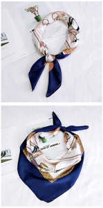Detail showing elegant equestrian print silk scarf with stirrups and horse shoe patterns