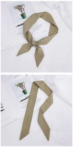 Detailed close-up of a versatile beige and black striped skinny scarf for hair and bags