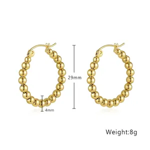 Close-up of gold beaded hoop earrings with 29mm outer diameter and 4mm bead size details
