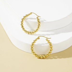 Elegant gold plated stainless steel beaded hoop earrings on a curved display stand