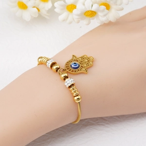 Gold Hamsa Hand evil eye snake chain bracelet with sparkling rhinestones worn on wrist
