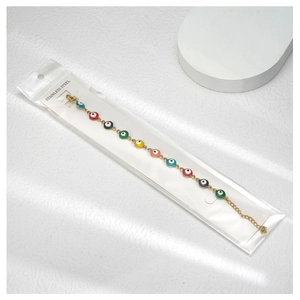 Macro shot of colorful enamel evil eye beads on a gold-plated stainless steel chain