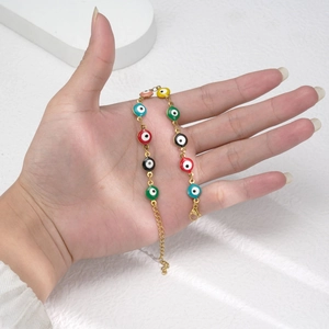Golden titanium steel bracelet with colorful Evil Eye enamel charms for ethnic fashion