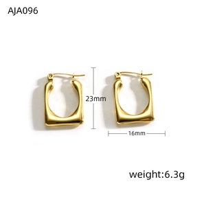 Macro detail showing 23mm height and 16mm width of golden twisted U-shaped earrings