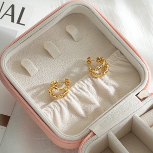 Textured 18k gold plated stainless steel twisted double hoop earrings in a jewelry box