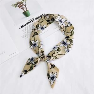 Detail of floral chiffon scarf tied on a magazine, showing silky texture and pattern